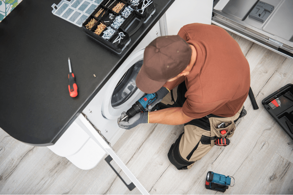 Bosch certified technician repairing a washing machine in Dubai home